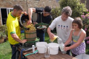 filling the press and pouring the juice