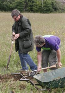 Simon and Huw preparing the ground for wild flowers
