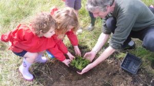 Mark Bianco helps children from the Histon Early Years Centre plant their wildflowers